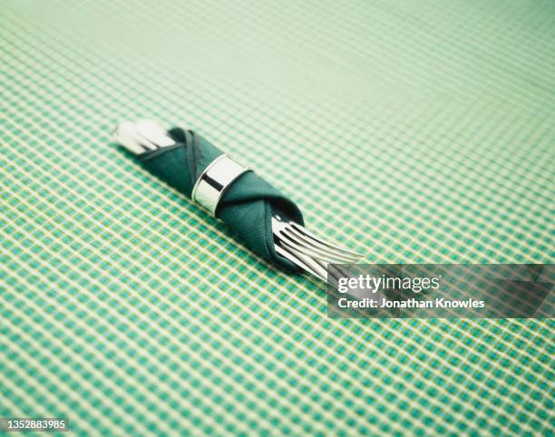 knife and fork wrapped in green napkin with napkin ring - napkin ring stock pictures, royalty-free photos & images