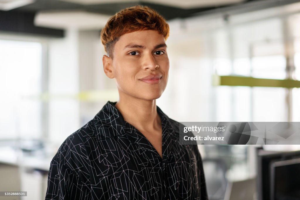 Portrait d’un jeune homme confiant debout dans son bureau