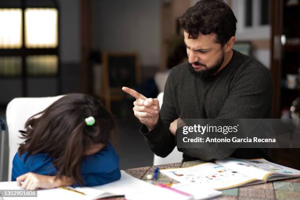 father and daughter joke while doing homework feigning severe scolding while girl cries and parodying exaggerated stock photo expressions - angry parent stock pictures, royalty-free photos & images