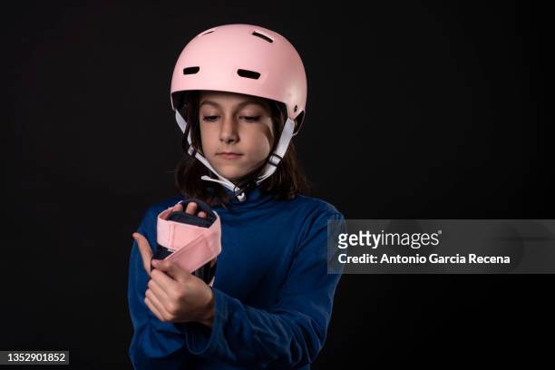 girl on black background studio shot with skate guard - protective sportswear ストックフォトと画像