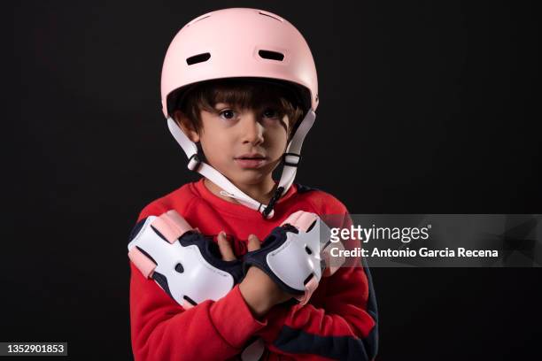 boy on black backgrund with skate guard - protective sportswear stock pictures, royalty-free photos & images