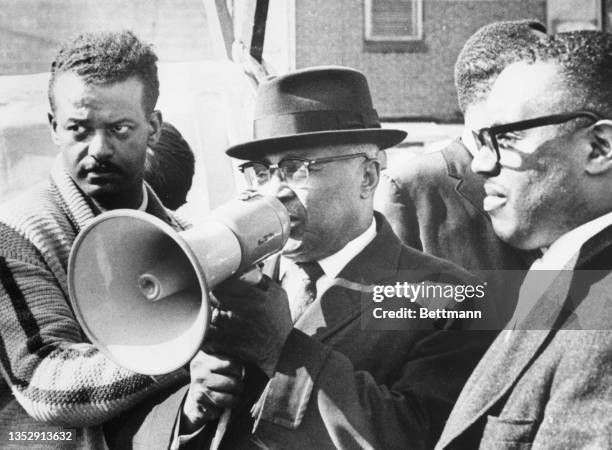 Reverend Doctor Martin Luther King Senior uses a bullhorn to talk to the demonstrators who have set up tents in a parking lot to protest the Boston...