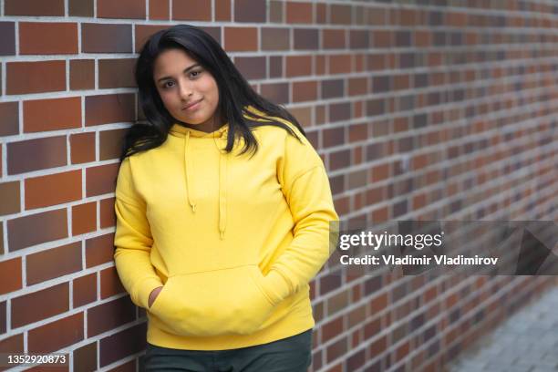 portrait of a beautiful teenage girl in front of a wall - fat girls stock pictures, royalty-free photos & images