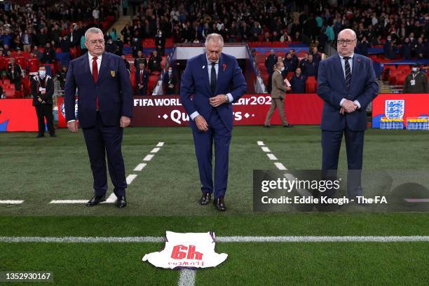 Sir Geoff Hurst MBE lays a shirt with '49' printed on in memory of Ronald Flowers MBE prior to the 2022 FIFA World Cup Qualifier match between...