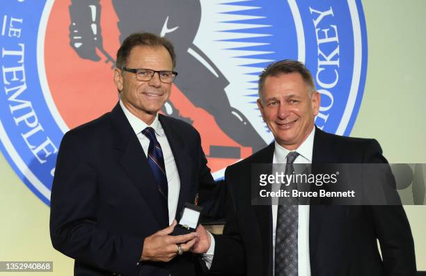Member of the selection committee Mike Gartner presents a Hall of Fame ring to Ken Holland at the Hockey Hall Of Fame on November 12, 2021 in...