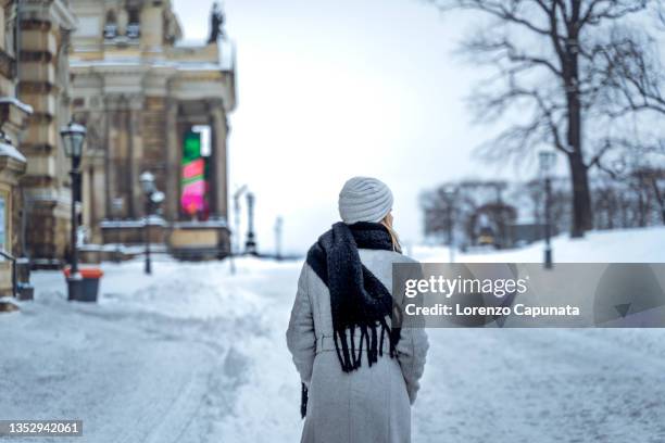 woman walking on snowy street - germany snow stock pictures, royalty-free photos & images