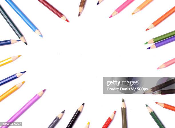 directly above shot of colored pencils on white background - stift freisteller stock-fotos und bilder