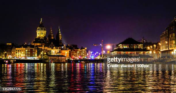 view of illuminated buildings at night,amsterdam,netherlands - amsterdam cityscape stock pictures, royalty-free photos & images