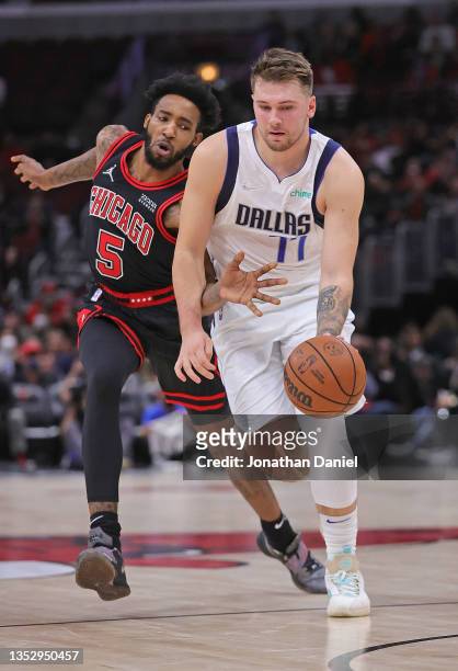 Luka Doncic of the Dallas Mavericks drives past Derrick Jones Jr. #5 of the Chicago Bulls at the United Center on November 10, 2021 in Chicago,...