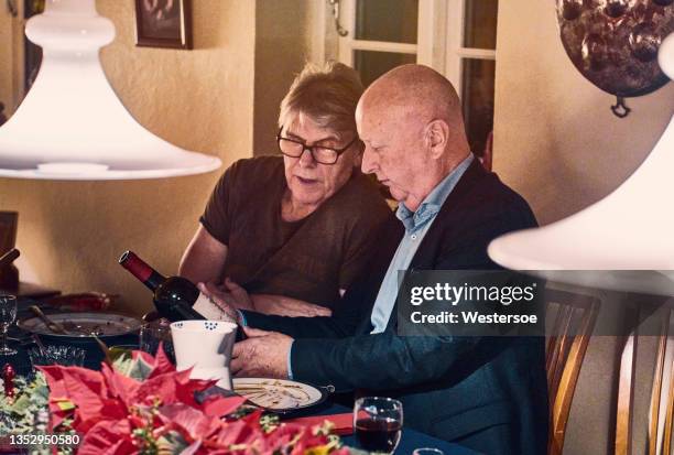 discussing the wine for the christmas dinner - christmas denmark stock pictures, royalty-free photos & images