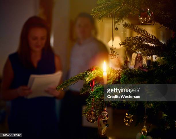 young woman singing at christmas tree - christmas denmark stock pictures, royalty-free photos & images
