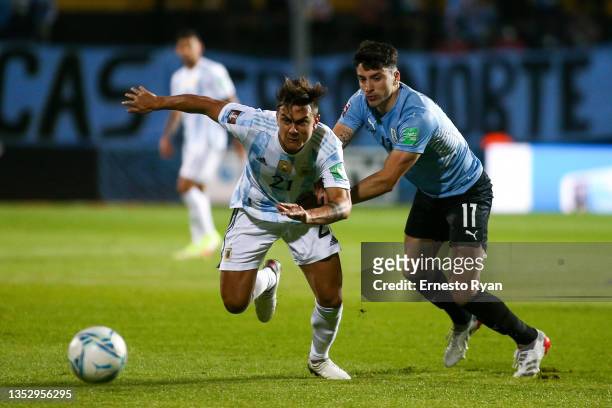 Paulo Dybala of Argentina fights for the ball with Gastón Pereiro of Uruguay during a match between Uruguay and Argentina as part of FIFA World Cup...