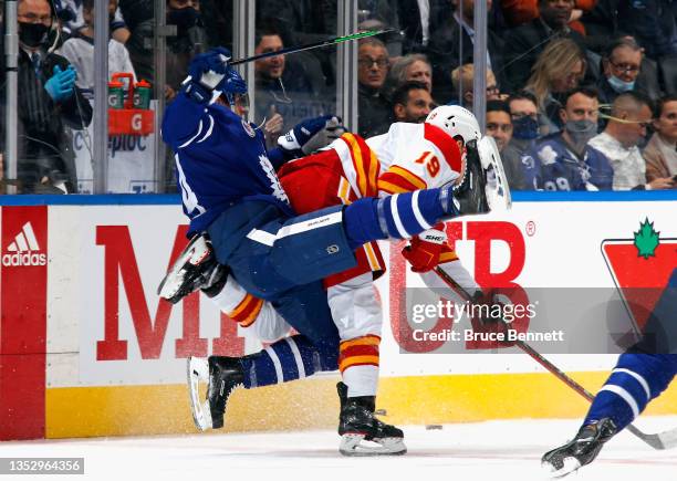 Matthew Tkachuk of the Calgary Flames backs into David Kampf of the Toronto Maple Leafs during the first period at the Scotiabank Arena on November...