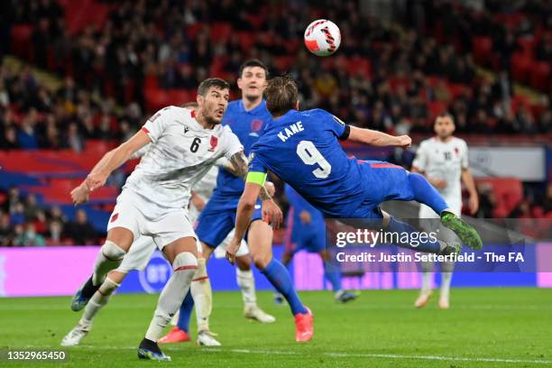 Harry Kane of England scores their side's fifth goal and his hat-trick whilst under pressure from Kastriot Dermaku of Albania during the 2022 FIFA...