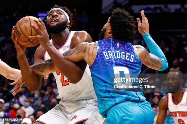 Mitchell Robinson of the New York Knicks attempts a shot against Miles Bridges of the Charlotte Hornets during the first half of their game at...