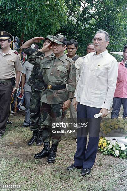 This photo taken on May 13, 1988 in La Negrita shows General Manuel Antonio Noriega next to Panama's President Manuel Solis Palma , saluting during...