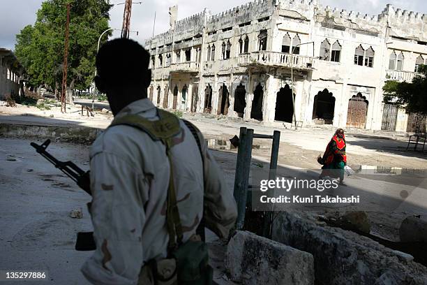 Transitional Federal Government soldier walks through destroyed buildings October 7, 2007 in the Shangani district of Mogadishu, Somalia. A large...