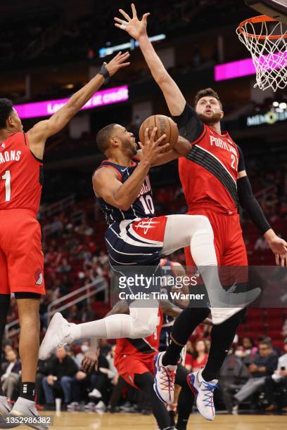 Eric Gordon of the Houston Rockets goes up for a shot while defended by Jusuf Nurkic of the Portland Trail Blazers in the first half at Toyota Center...