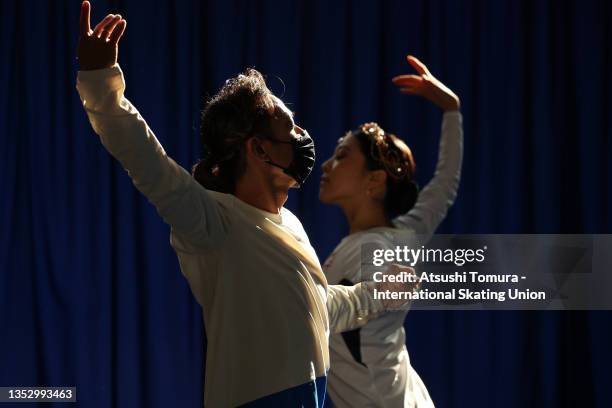 Kana Muramoto and Daisuke Takahashi of Japan are seen at the warming up area ahead of the Ice Dance Free Dance during the ISU Grand Prix of Figure...