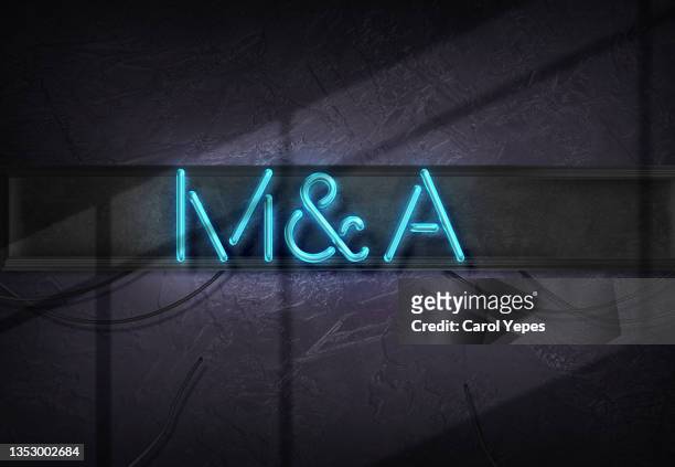 mergers and acquisitions message  in neon lights style - merger stock pictures, royalty-free photos & images