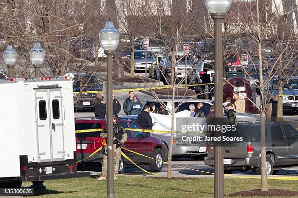 Police officers gather around the scene of a shooting in front of Cassell Coliseum on the Virginia Tech campus December 8, 2011 in Blacksburg,...