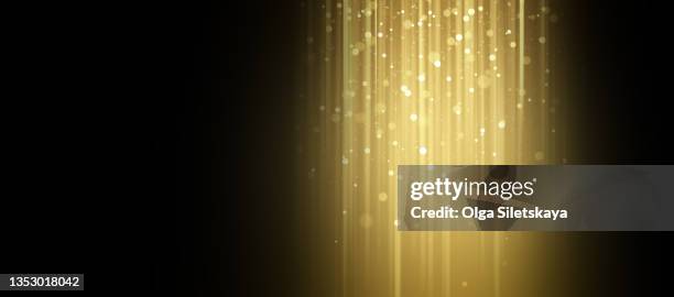 golden glow with defocused lights on black background - nebula gold stock-fotos und bilder