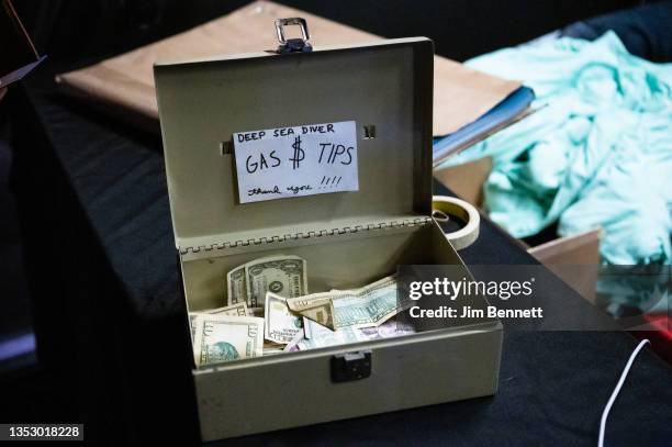 Tip box on the merchandise table collects funds for Deep Sea Diver while they perform live on stage at The Showbox on November 12, 2021 in Seattle,...