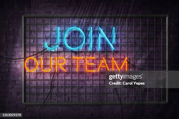 join our team text in neon lights - wanted foto e immagini stock