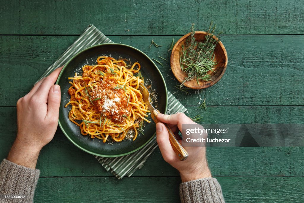 Man Eating Classic Spaghetti Bolognese
