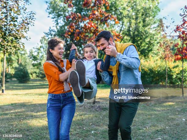 happy family playing on the nature - life insurance stockfoto's en -beelden