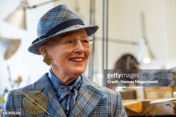 Queen Margrethe II of Denmark sits in a jewellery workshop during her visit to the Academy of Fine Arts on November 13, 2021 in Munich, Germany. The...