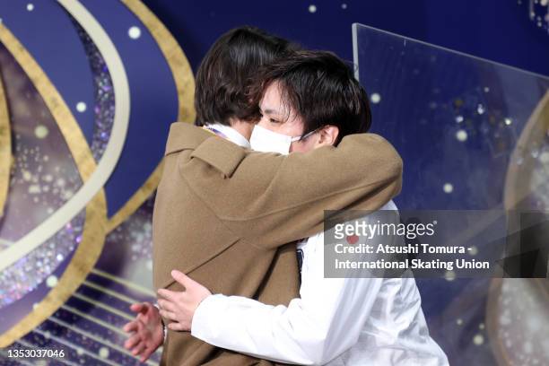 Shoma Uno of Japan is congratulated by his coach Stephane Lambiel after winning the gold at the kiss and cry after competing in the Men's Free...