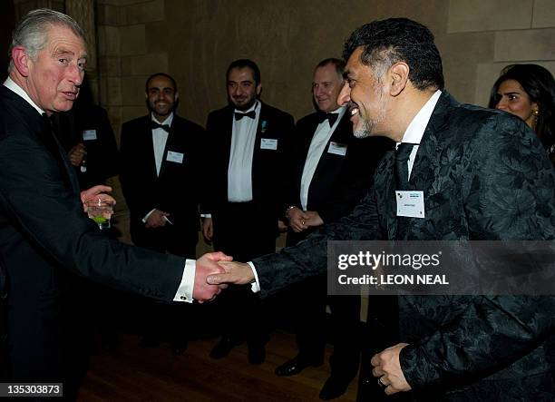 The Prince of Wales shakes hands with Pakistani entrepreneur and television personality James Caan at a dinner in the Natural History Museum, London...
