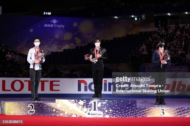 Silver medalist Vincent Zhou of the United States, gold medalist Shoma Uno of Japan and bronze medalist Junhwan Cha of South Korea pose on the podium...