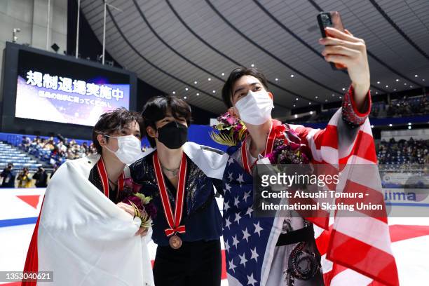 Gold medalist Shoma Uno of Japan, bronze medalist Junhwan Cha of South Korea and silver medalist Vincent Zhou of the United States pose for a selfie...