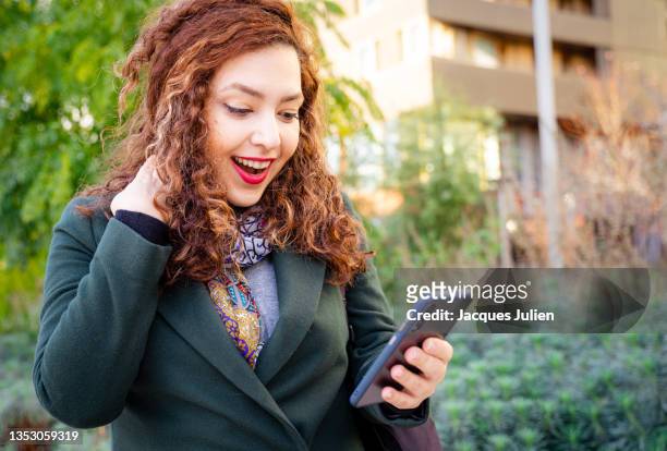 woman watching smartphone looking surprised - beautiful armenian women stock pictures, royalty-free photos & images