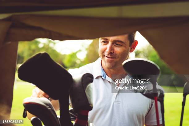 man chooses his golf club from a golf bag - course caddie stock pictures, royalty-free photos & images