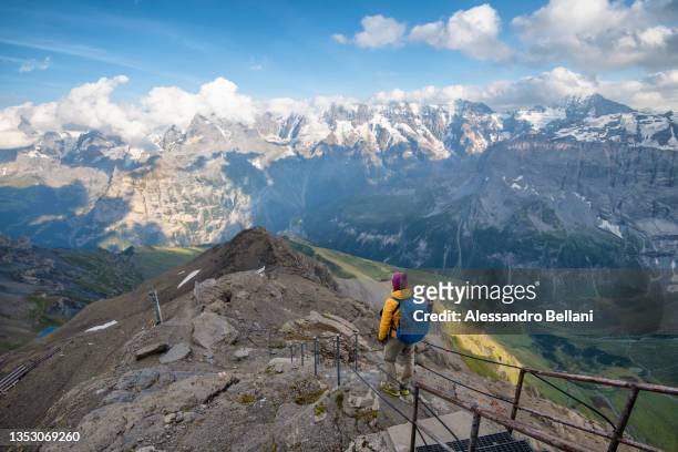 photographer admires landscape from schilthorn piz gloria, switzerland - eiger mönch jungfrau stock pictures, royalty-free photos & images