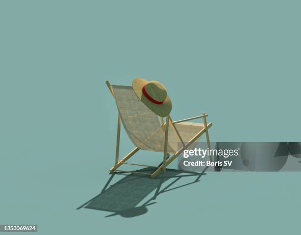 beach chair with sun hat - pensioen thema stockfoto's en -beelden