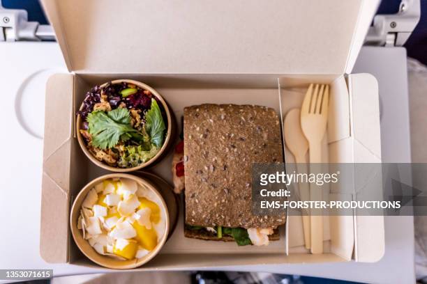 directly above shot of eating economy class lunch set on the plane - paper plane ストックフォトと画像