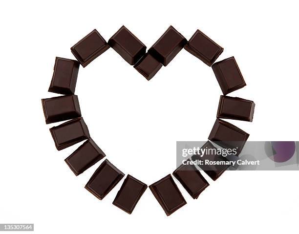 dark chocolate illustrating love & heart health. - dark chocolate stock pictures, royalty-free photos & images