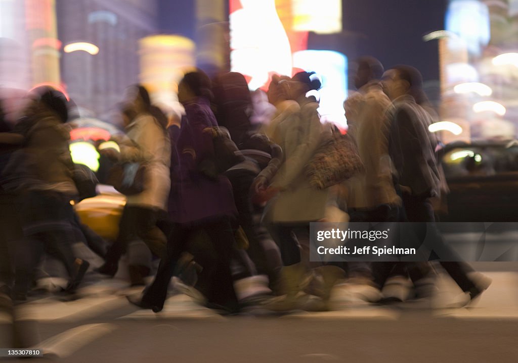 Commuters Crossing Street During Evening Rush Hour