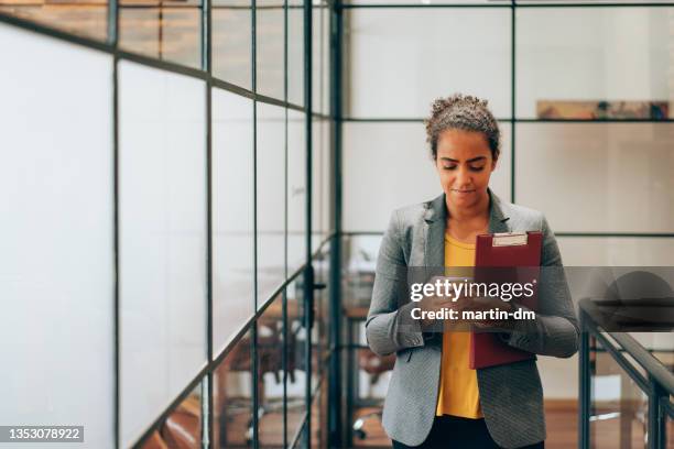 businesswoman texting in the office - teacher with folder stock pictures, royalty-free photos & images