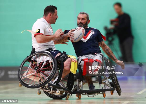 Gilles Clausells of France is tackled by Seb Bechara of England during the International Wheelchair Rugby League Test Series between England and...