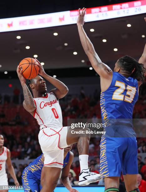 Marcus Sasser of the Houston Cougars drives to the basket during the second half against Kvonn Cramer of the Hofstra Pride at Fertitta Center on...