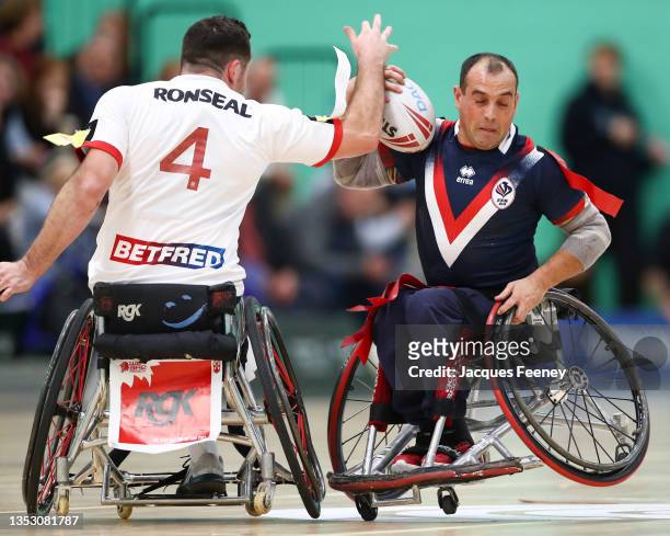 Seb Bechara of England tackles Lionel Alazard of France during the International Wheelchair Rugby League Test Series between England and France at...