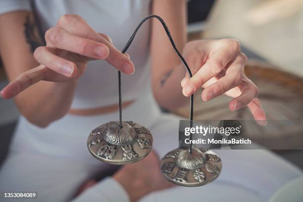 woman holding tibetan bells - tibetansk kultur bildbanksfoton och bilder