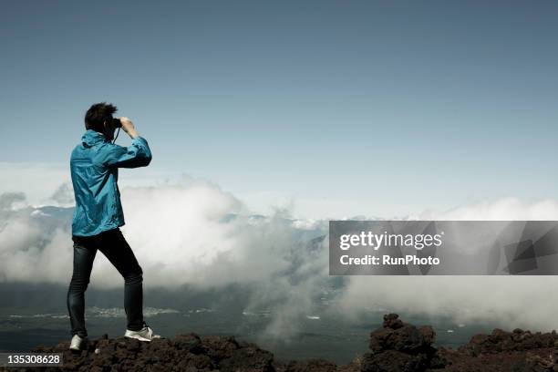 man with binoculars at the mountain - binoculars imagens e fotografias de stock