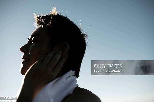 young man listening to music,close-up - young man asian silhouette stock pictures, royalty-free photos & images