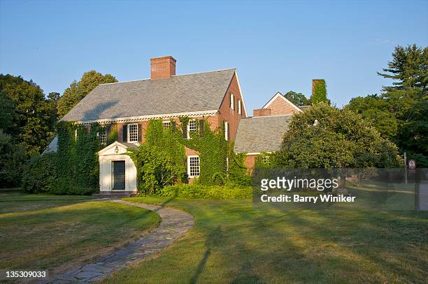 large brick building covered with green ivy. - concord massachusetts stock pictures, royalty-free photos & images